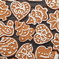 Christmas gingerbread handmade on a black wooden background. A look from above. New Year's concept.