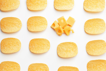 Tasty potato chips and cheese on white background