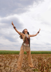 An Indian girl is seen in a dried out crop field. Her unhappy face reveals that the land is dried ...