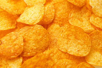 Tasty potato chips as background
