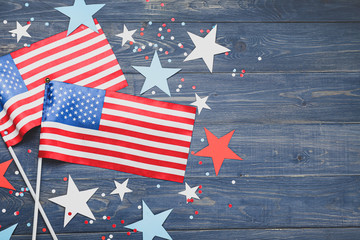 USA flags and stars on wooden background. Memorial Day celebration