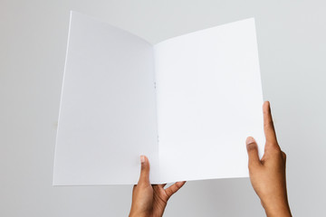 Woman of color holding a letter size or A4 brochure mockup