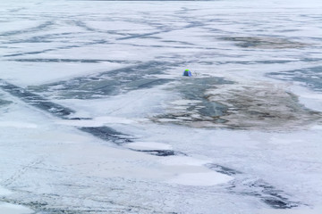 View of the frozen city pond from the waterfront. Frozen pond in the city park.