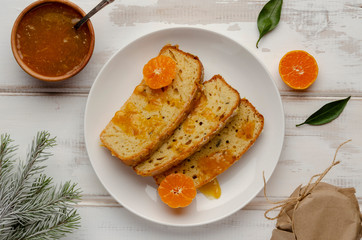 cake with tangarine marmalade jam in glass jar. Christmas winter mood. Homemade citrus cinnamon