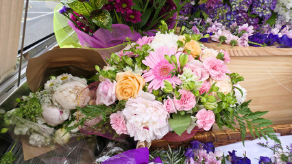 closeup shot of a funeral casket in a hearse or chapel or burial at cemetery