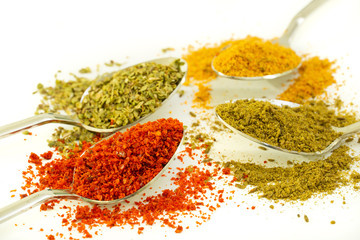 various spices. red pepper, black pepper and curry on white background