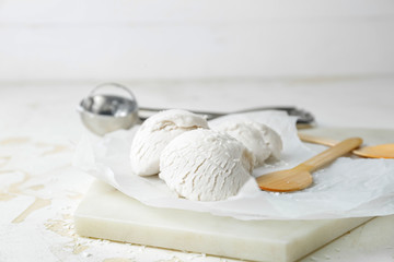 Tasty coconut ice-cream on table