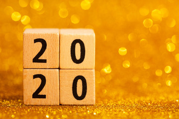Horisontal numbers of 2020 on golden sparkling background. Place for text. Festive concept.