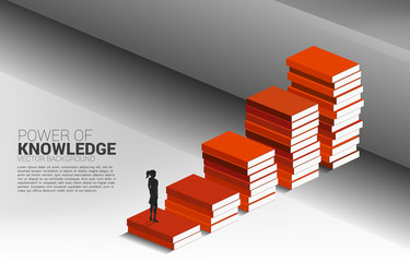 Obraz premium Concept background for power of knowledge. Silhouette of businesswoman move to cross wall with step from book stack.