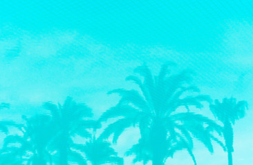 Fototapeta na wymiar inverted reflection of palm trees in the pool toned in color Aqua Menthe