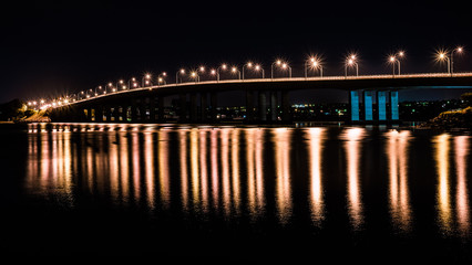 Fototapeta na wymiar Bridge at night with reflections