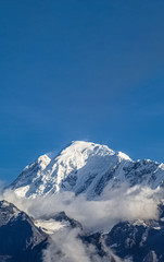 Beautiful Shot of a Snowy Mountain With Clear Blue Sky