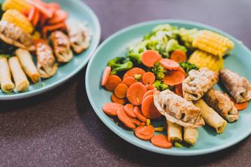 steamed vegetables with spring rolls and asian dumplings