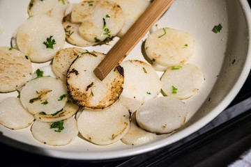 Frying japanese golden nagaimo with cilantro