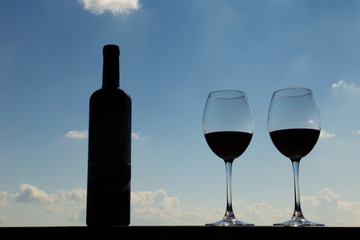 Bottle of wine and wine glasses on wooden.