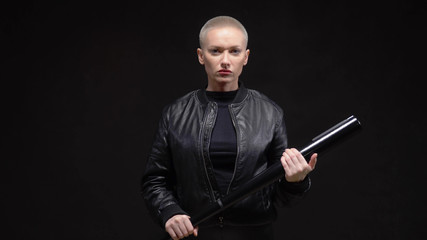  short haired blond woman in a black leather jacket with a baseball bat 