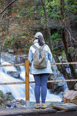 Spanish tourist woman looking a small river in the Spanish mountain Montseny