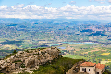 Fototapeta na wymiar Picturesque green hilly valley near Enna city, Sicily, Italy. Nicoletti Lake and Leonforte town on the background. Aerial view from Castello di Lombardia