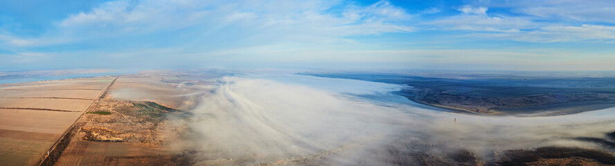 Naklejka na ściany i meble Aerial landscape. Fog above the fields