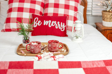 Two cups of hot chocolate on a tray in the bedroom at Christmas time