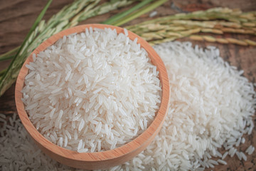 Jasmine rice in a wooden bowl with background.