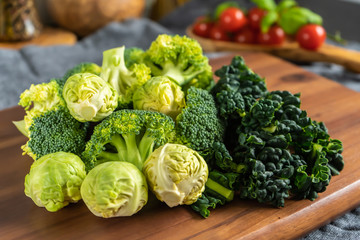 Broccoli, brussels sprouts and cavolo nero kale on a wooden board