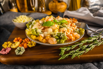 Pasta with shrimp and cream sauce, colorful Italian pasta on a plate