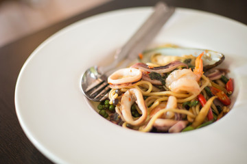 Selective focus of Seafood spaghetti in  a white plate