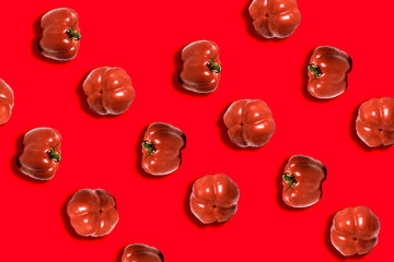 fresh whole sweet red pepper on red background