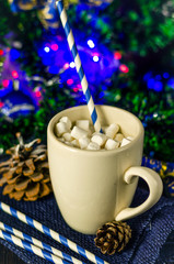 cup of drink with marshmallows on christmas background