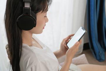 asian young woman listen to the music at home