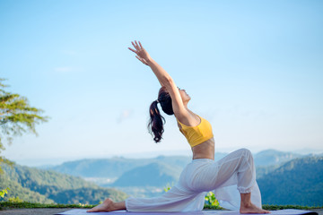 Side view of healthy women practicing yoga. standing in Warrior I pose.asana Anjaneyasana - low...