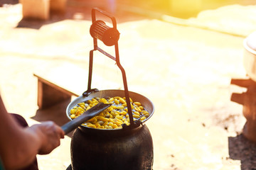 Boiling yellow silkworm cocoons by boiler to make silk thread.