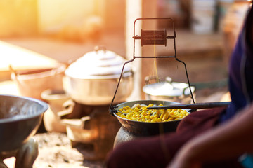 Boiling yellow silkworm cocoons by boiler to make silk thread.