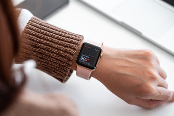 CHIANG MAI ,THAILAND FEB 24, 2019 : Woman hand with Apple Watch Series 4 with Heart Rate on the screen. Apple Watch was created and developed by the Apple inc.
