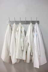 Lab coats hanging hooks at laboratory