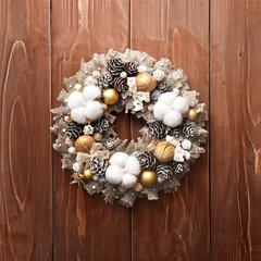 Beautiful Christmas wreath on wooden background. Manual work. preparation for Christmas