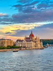 Obraz premium The Hungarian Parliament Building located on the Danube River in Budapest Hungary at sunset.