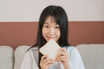 asian young woman having breakfast at home