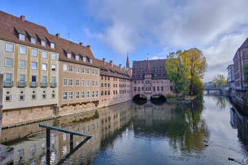 Scenic view of Pegnitz river between old houses in Nuremberg - second-largest city of federal state of Bavaria in Germany. Beautiful summer sunny look of small river in ancient city in Europe