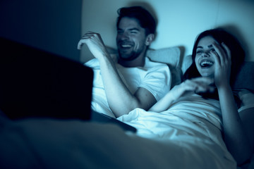 Fototapeta premium young man sitting on sofa and watching tv