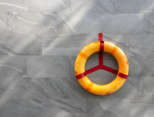 lifebuoy is hanging on the steel, rescue equipment for swimming pool, help and safety, blank space for text