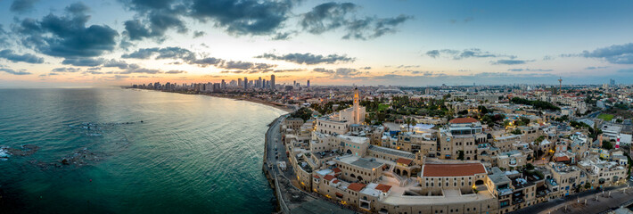 Aerial view of Tel Aviv Yafo along the Mediterranean sea at predawn with colorful sky over the city...