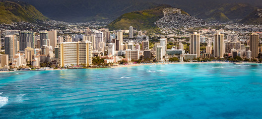 Honolulu waikiki beach cityscape shot from helicopter at summer sunset time from the sky, aerial...