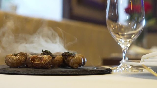 serving cooked snails close up