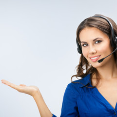 Portrait of happy smiling cheerful young support operator or sales phone agent, showing blank copy space area for slogan or text