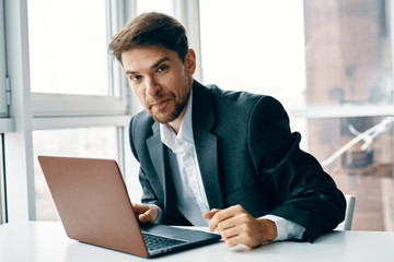 businessman sitting at desk and working on laptop