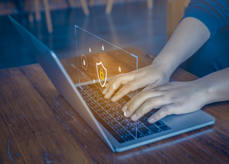 Businessman using a laptop computer with technology cybersecurity and privacy concept. protection and safe data for global network security.