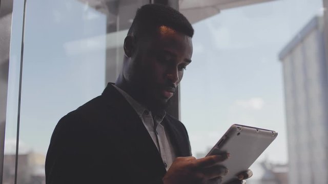Entrepreneur reading news on tablet in elevator