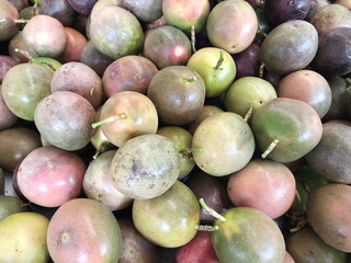 Multicolored fruits of ripe passion fruit sold in the market.